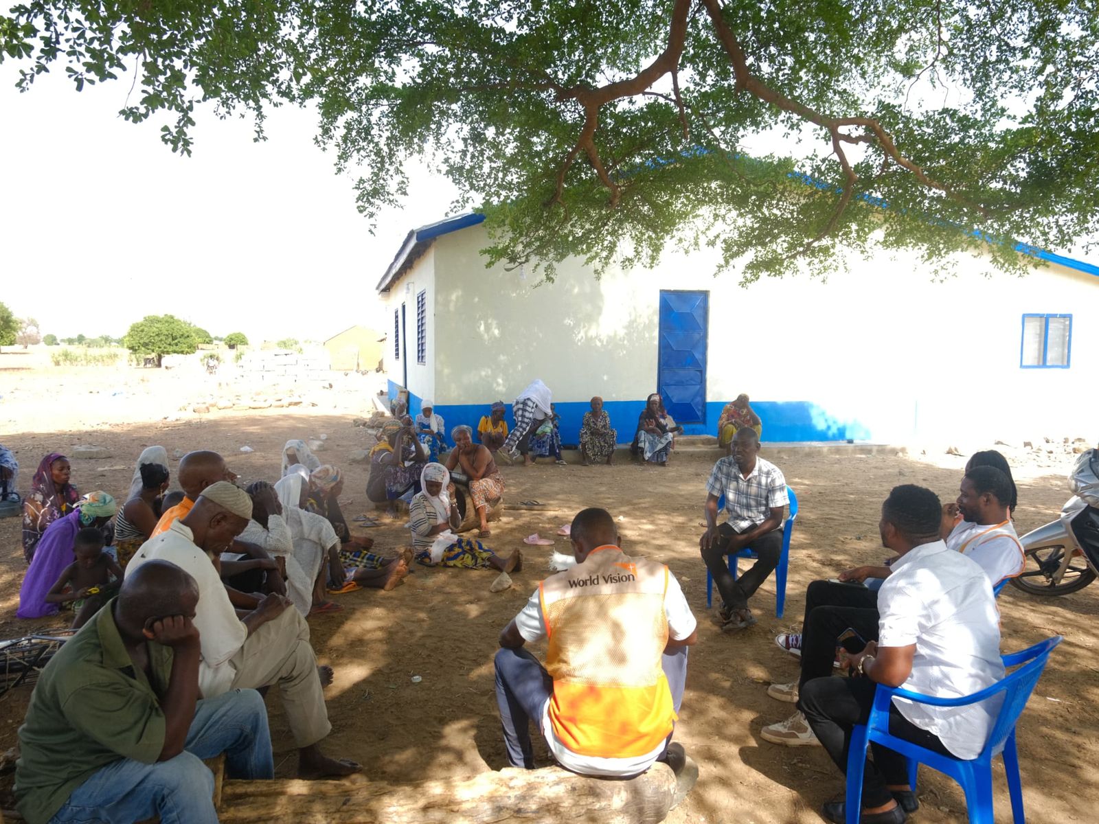 Community volunteers meeting near a health facility